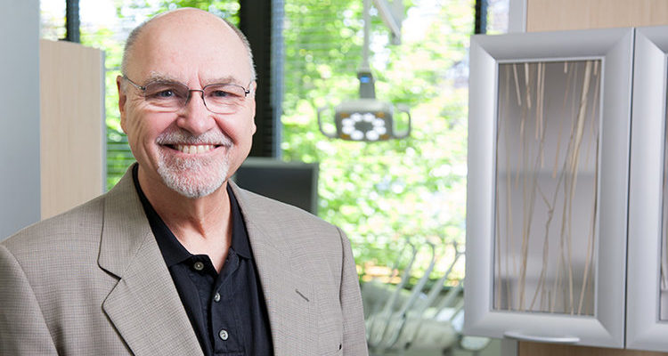 A portrait of Dr. Mark Tholen, a luxury dental office designer smiling at the camera