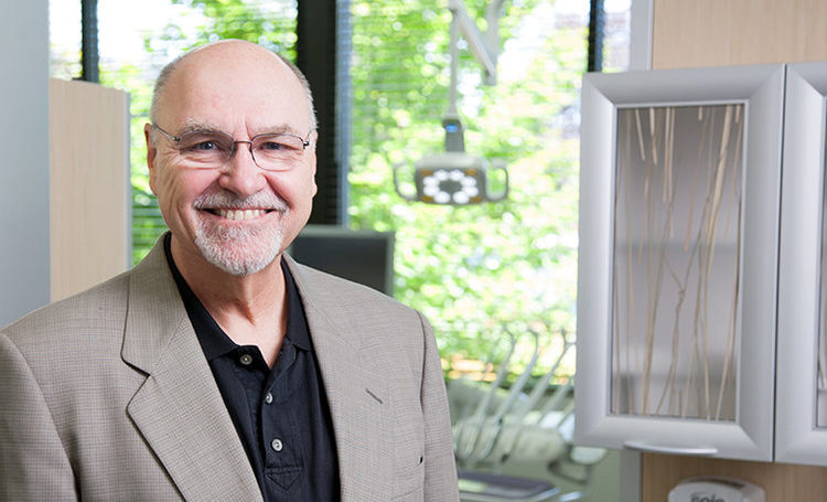 A portrait of Dr. Mark Tholen, a luxury dental office designer smiling at the camera